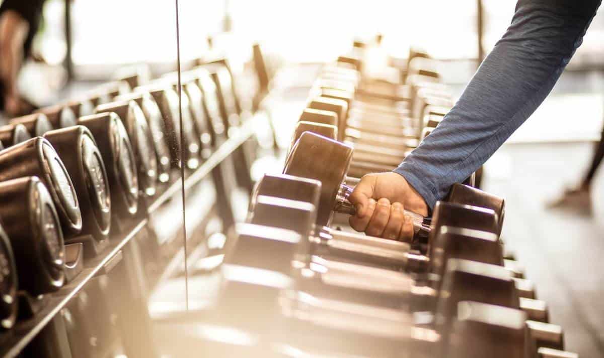 Man working out in a full gym