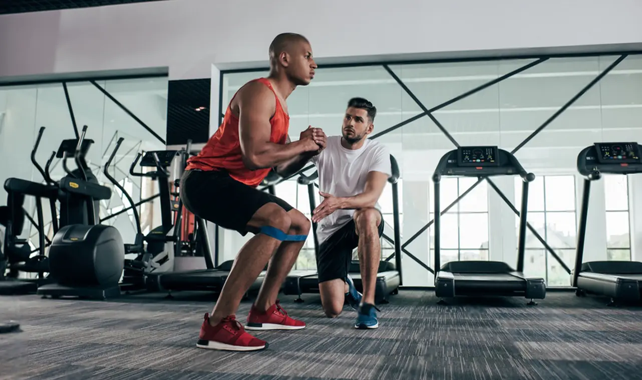 Man working out in a full gym