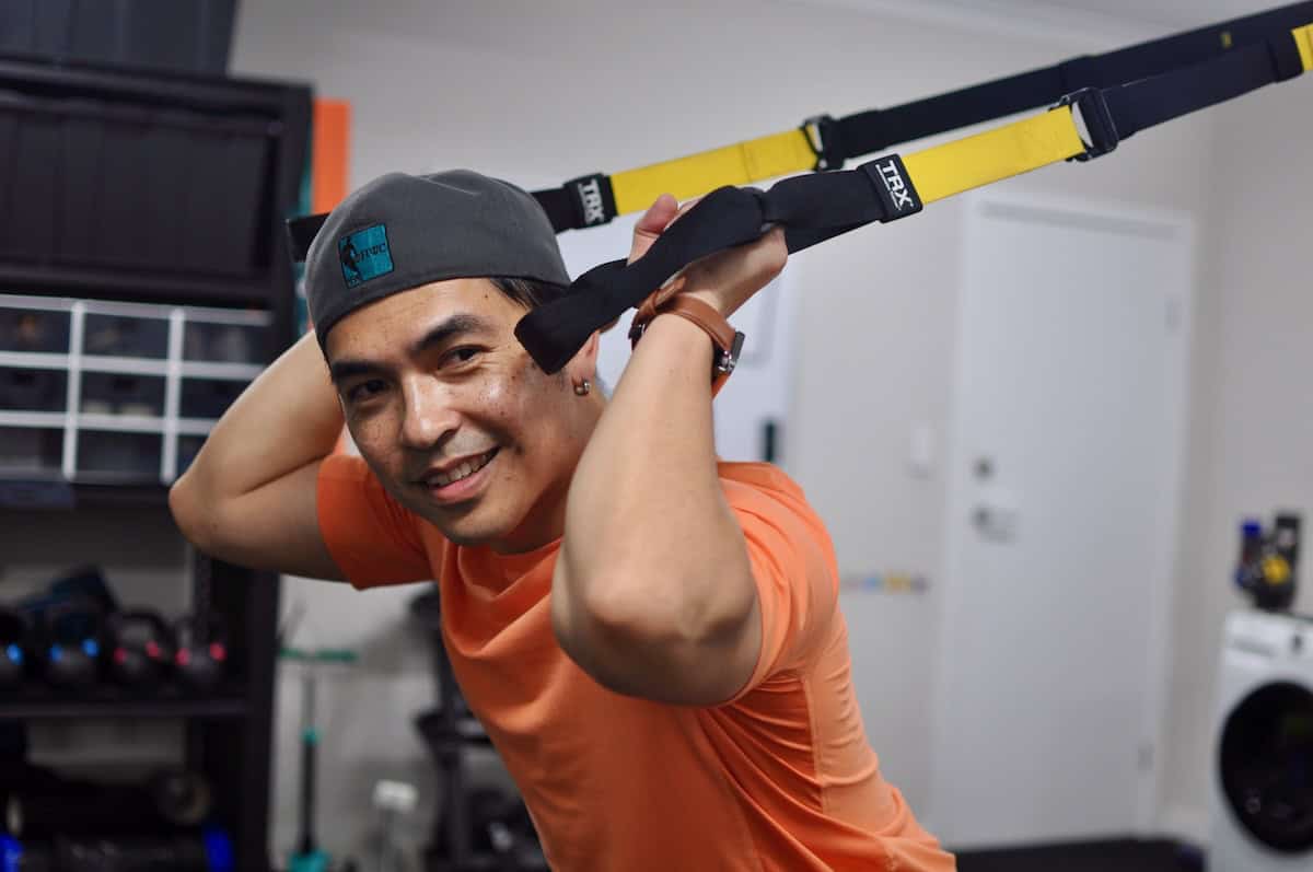 Mike smiling and hanging on TRX bands